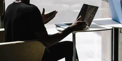 man sitting front of laptop